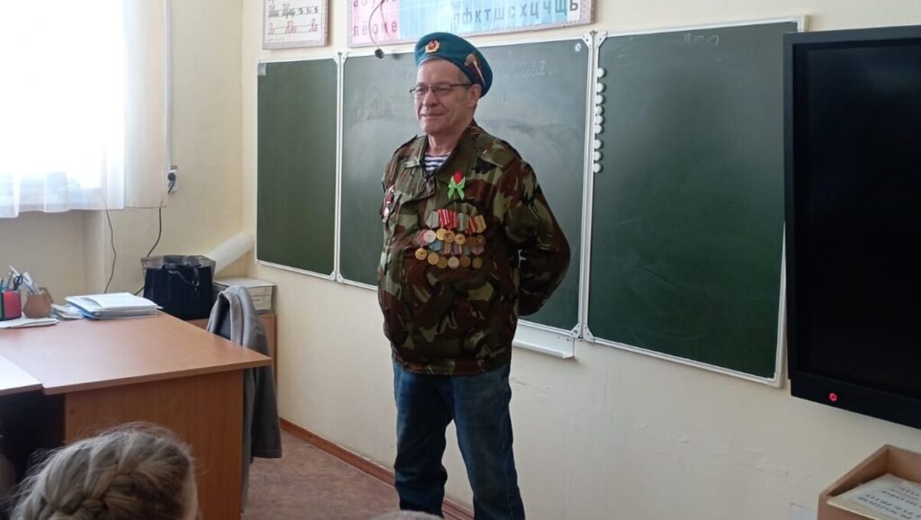 Флуз Рафкатович Нигаматьянов выступает перед школьниками на уроке мужества. Ветеран-десантник в камуфляжной форме и с медалями рассказывает детям о службе, патриотизме и жизненном пути.