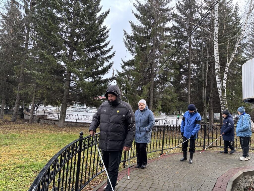 незрячие передвигаются с тростью вдоль забора