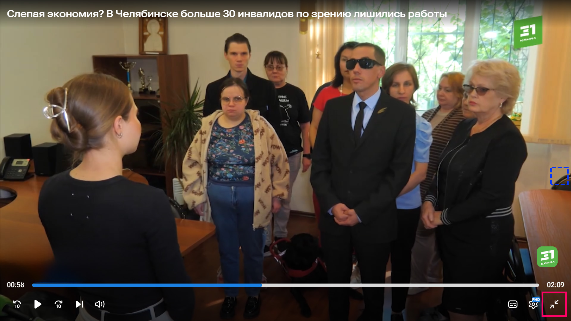 кадр из сюжета 31 канала: вместе стоят сотрудники чооо вос, впереди председатель даёт интервью